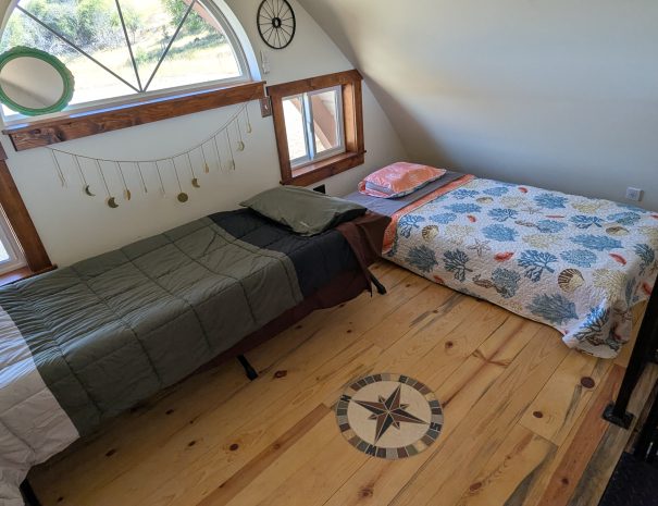 LOFT: You have a  regular twin bed (38x75 inches), and a Teton XXL cot; 35.5 inches x 80 inches. The cot features aTeton sleeping pads. The loft is accessed by a narrow spiral staircase.