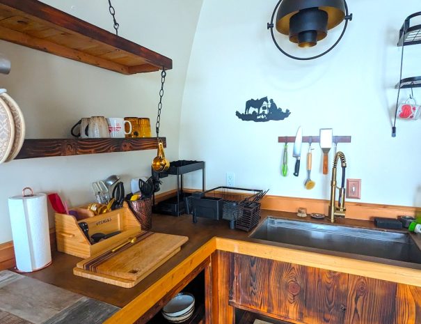 FULL KITCHEN: Your kitchen features a farmhouse sink, cutting board, microwave, propane burners, utensils, mugs, plates, cutlery and fridge/freezer.FULL KITCHEN: You can wash vegetables and later dishes in the farmhouse sink.