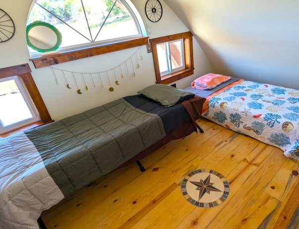LOFT: You have a  regular twin bed (38x75 inches), and a Teton XXL cot; 35.5 inches x 80 inches. The cot features aTeton sleeping pads. The loft is accessed by a narrow spiral staircase.